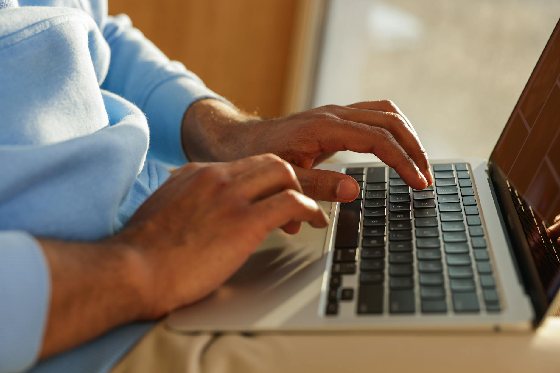 Focused image of hands typing on a laptop, ideal for business and tech themes.
