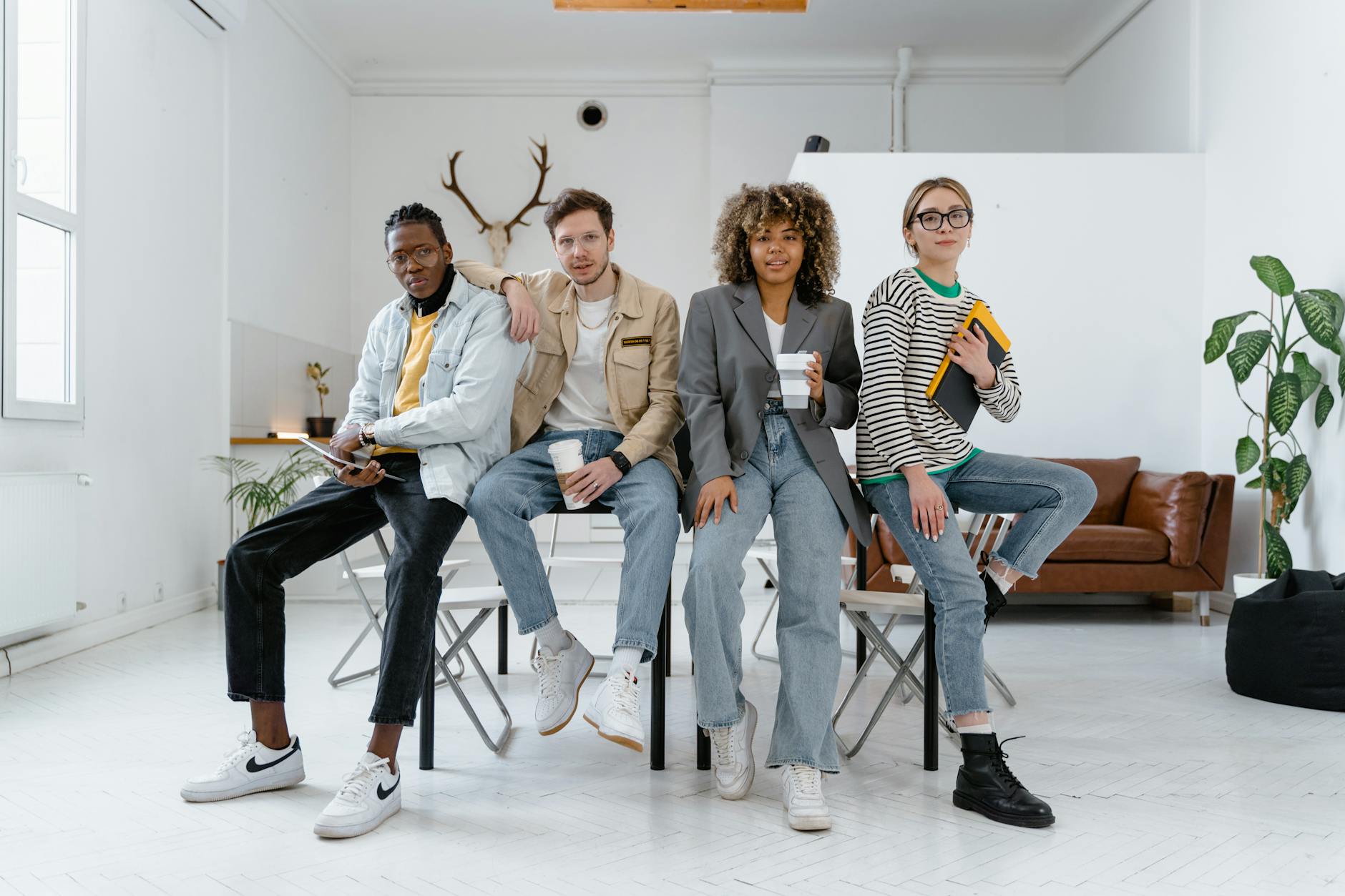 A multicultural group of young professionals in a modern office setting, showcasing teamwork and creativity.