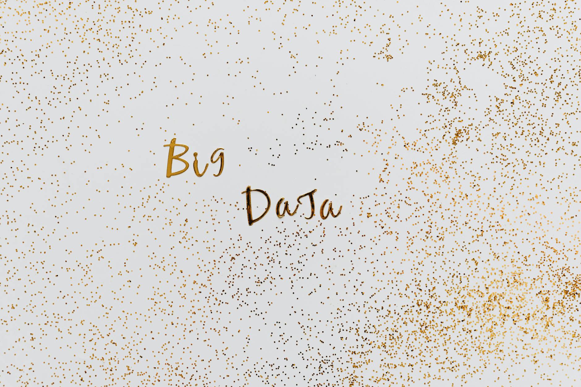 Creative representation of big data with gold particles on white background.