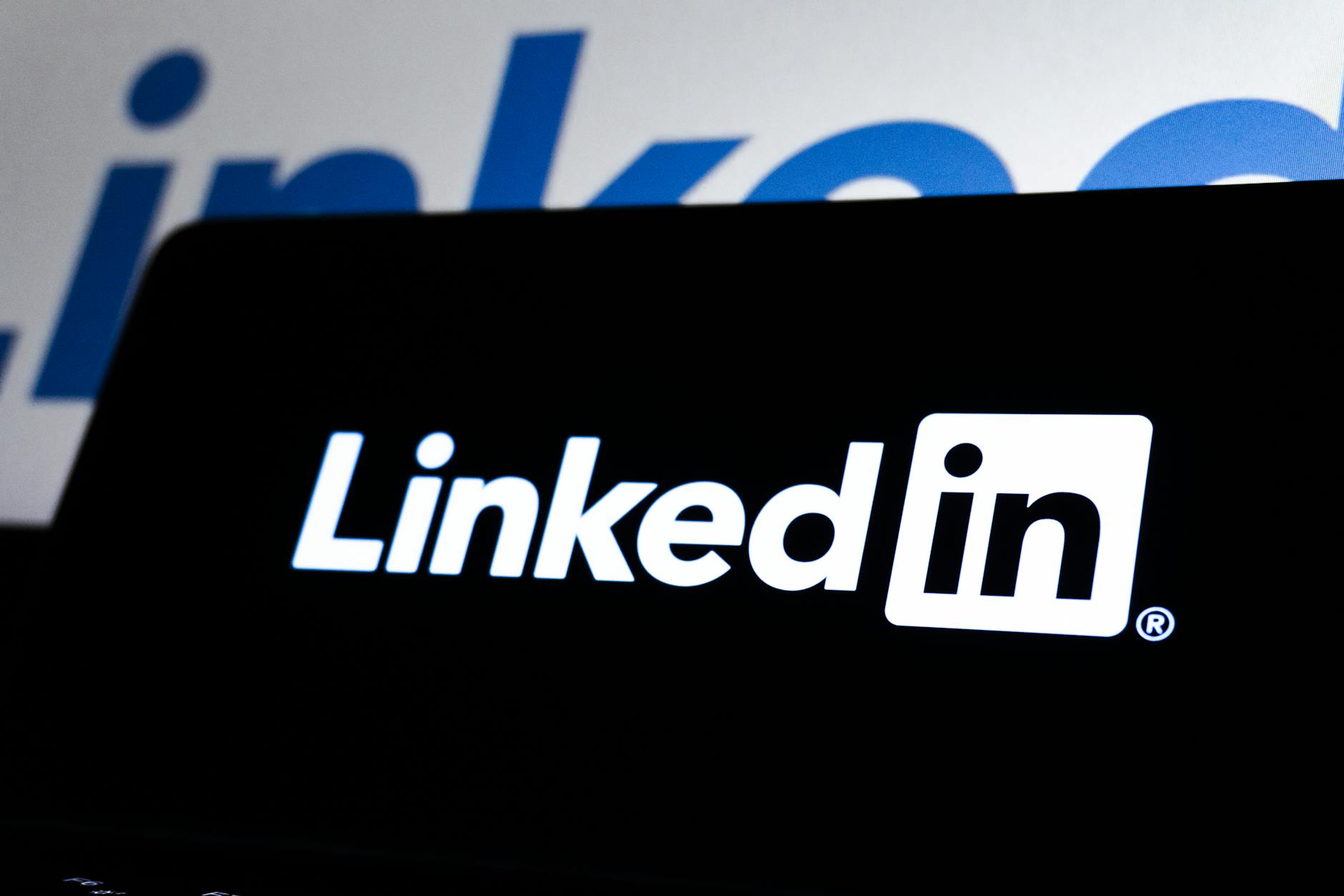 High contrast image of LinkedIn logo displayed prominently on a dark screen.