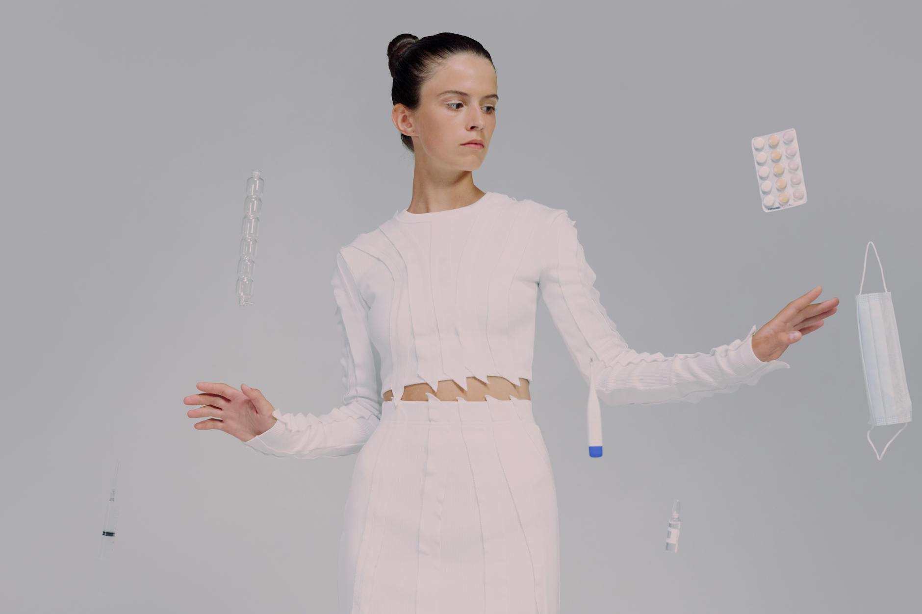 Female scientist interacting with floating medical items, emphasizing modern medicine.